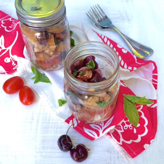 A portable summer salad perfect for the beach or a picnic featuring cherries, tomatoes, basil, mint, fresh mozzarella and bread - recipe for Cherry Caprese Panzanella at Teaspoonofspice.com