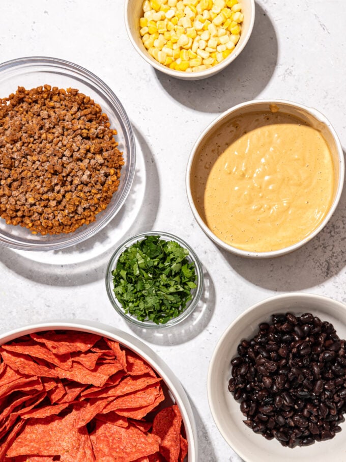 tortilla chips, queso, veggie ground and black beans in bowls