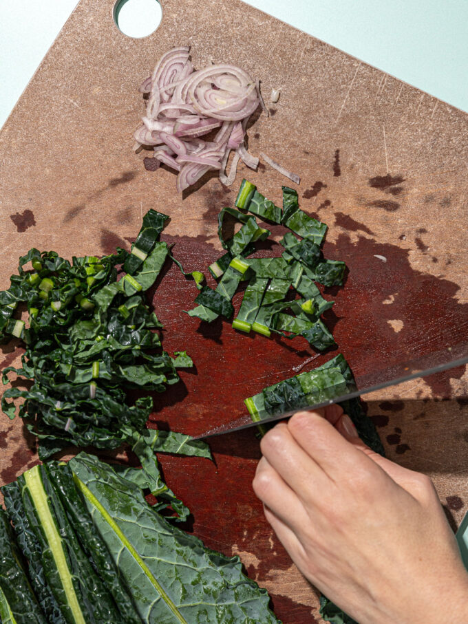 hand slicing kale