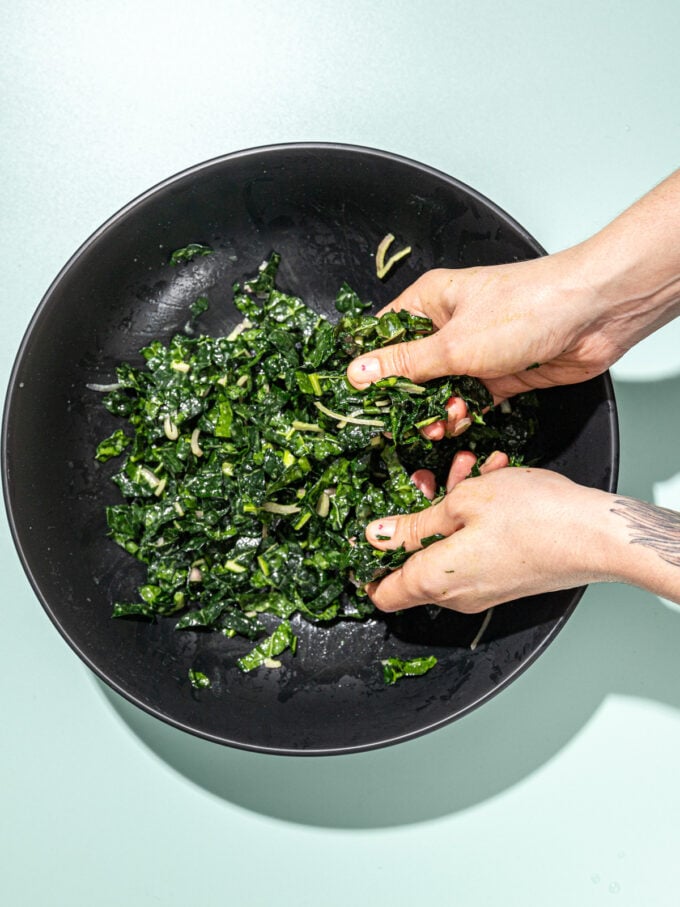 hand massaging kale